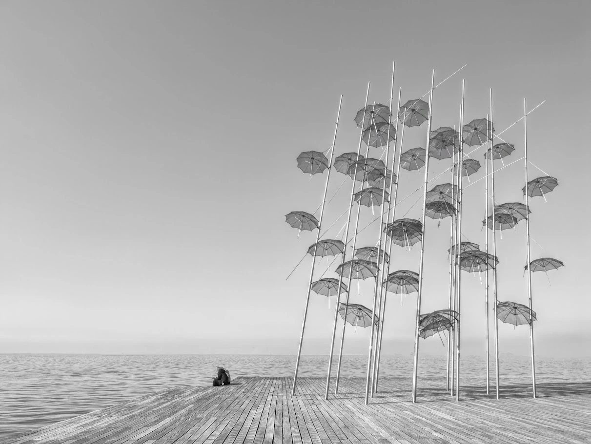 Couple sitting near The Umbrellas in Thessaloniki, Greece